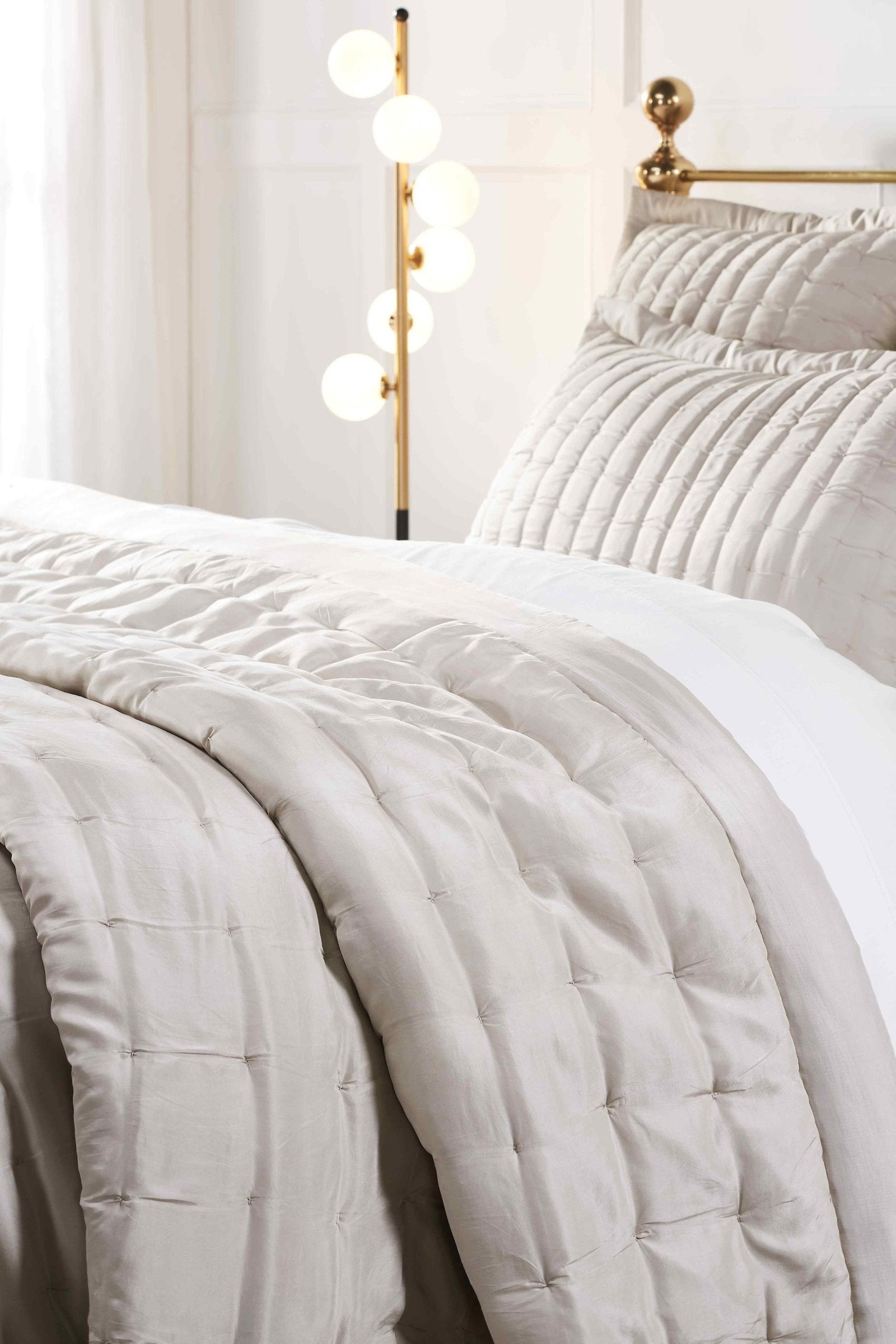 QT-334-11096_3|Close-up of a luxurious light grey square-quilted quilt and matching pillow sham, enhancing bedroom comfort.