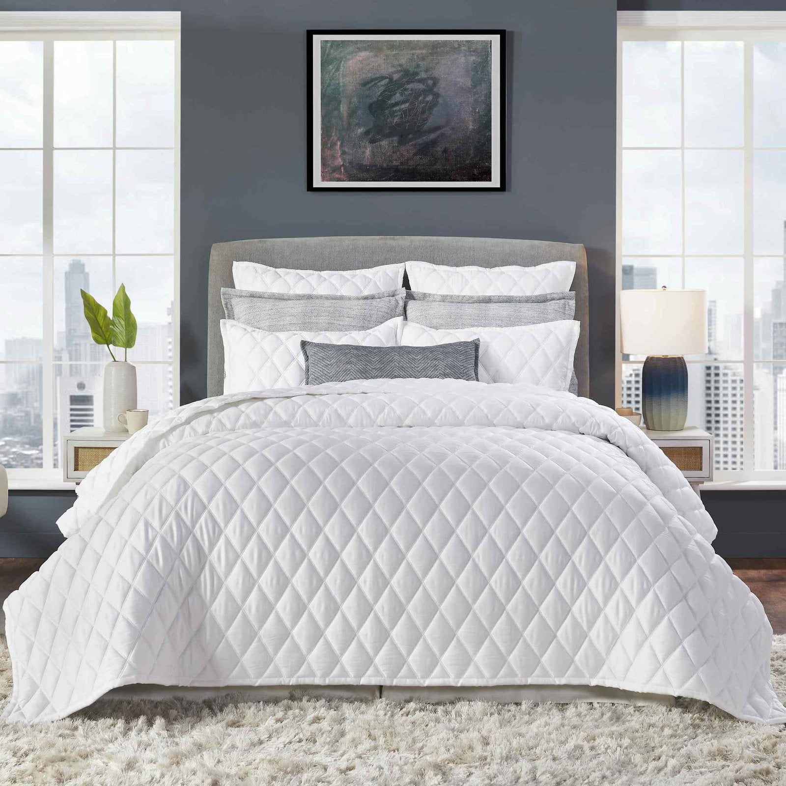 CL-179-11096_1|Crisp white diamond quilted coverlet styled in a modern bedroom setting, providing elegant comfort and plush texture.