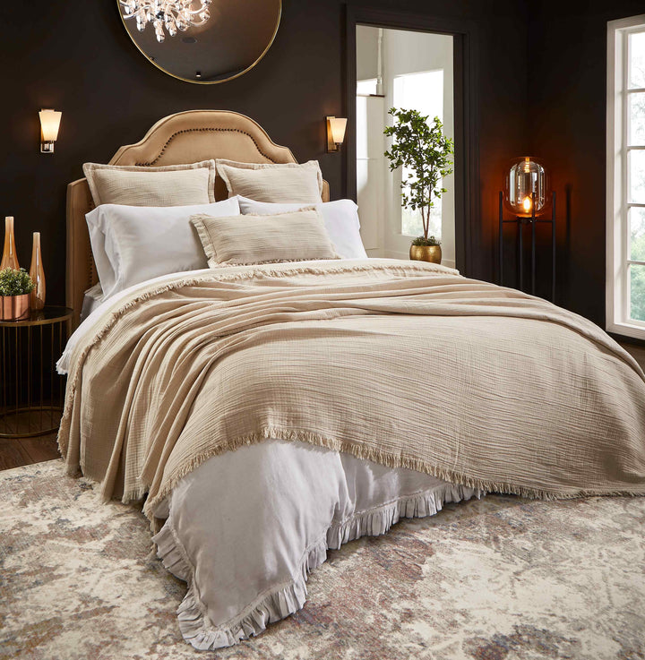 BT-115-11096_1|Luxurious beige textured blanket with a stylish fringe edge draped over a bed, adding warmth and elegance to modern bedroom decor.