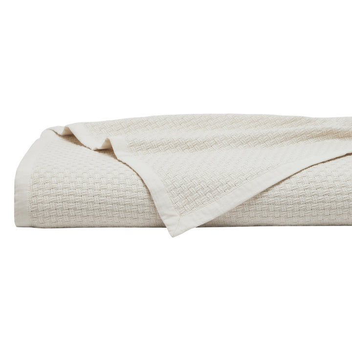 BL-868-9496_1|Folded cream herringbone weave blanket. Stylish, durable cotton throw for beds, couches, offering warmth and modern home decor.