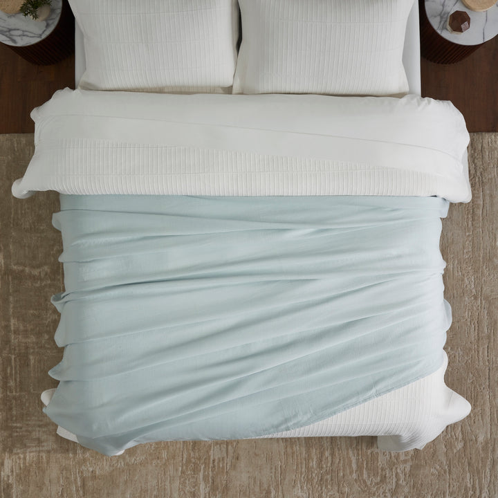 BL-859-9496_4|Aerial view of a light blue waffle weave blanket loosely draped across a white bed. Provides casual comfort and style.