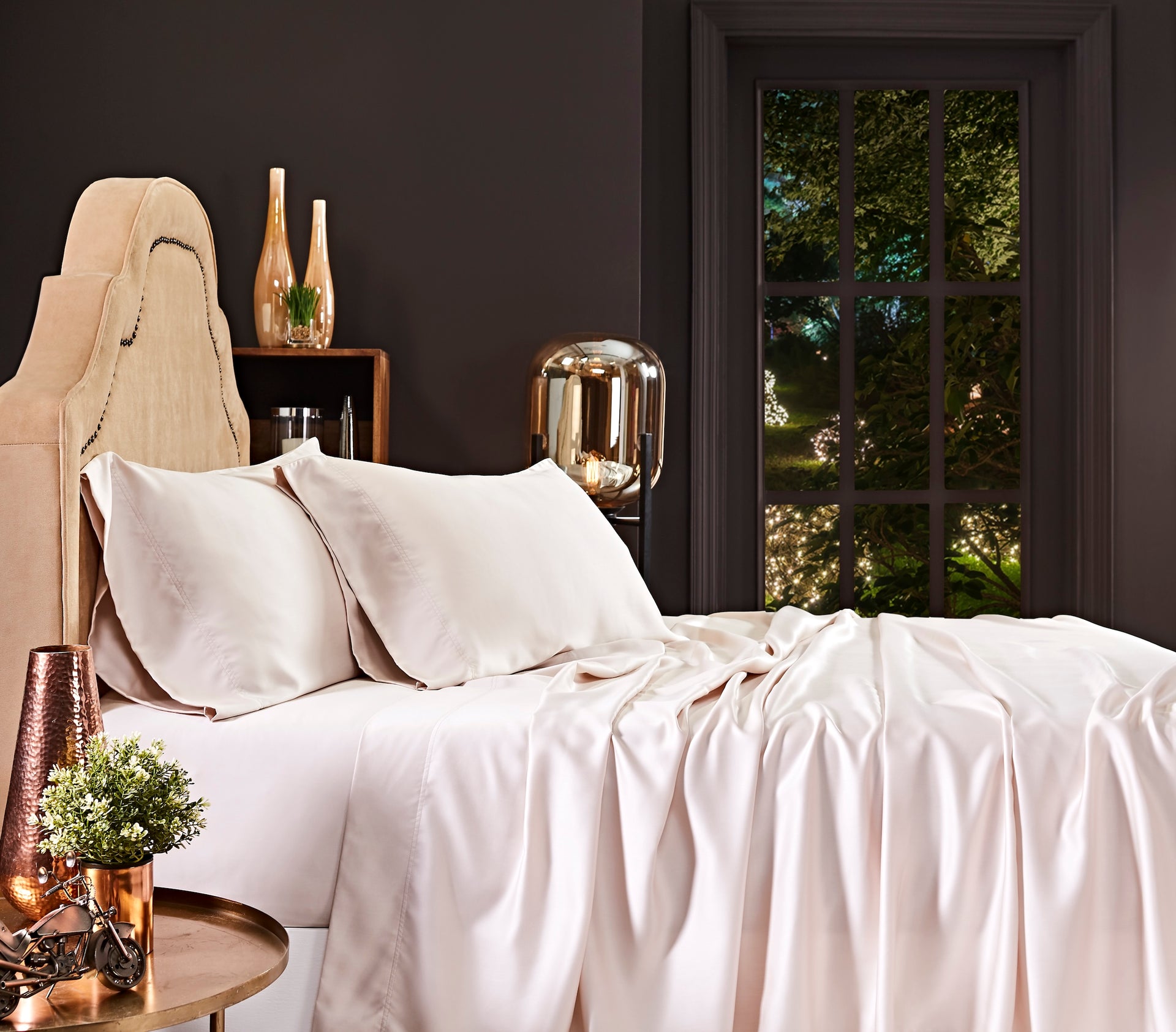 QSS-509-X_1|Pale beige 100% Lyocell sheet set on a bed. Includes two pillowcases and a flat sheet with a sateen weave.