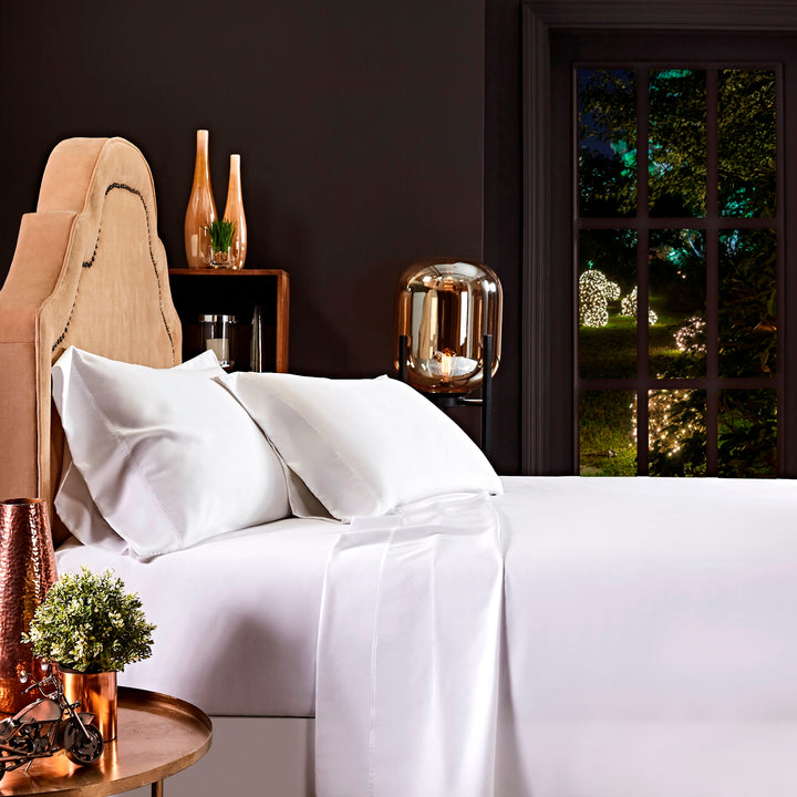 QFL-509-6080_1|Luxurious white 100% Lyocell sheets draped over a bed, with smooth, breathable fabric, perfect for a comfortable night's sleep.