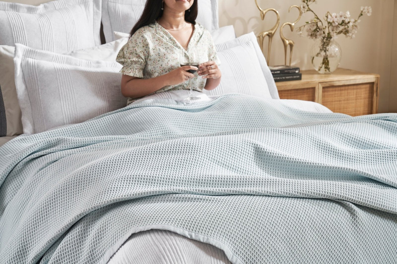 BL-857-11096_5|Woman relaxing in bed, covered by a light blue waffle knit blanket, for ultimate cozy comfort. (111)