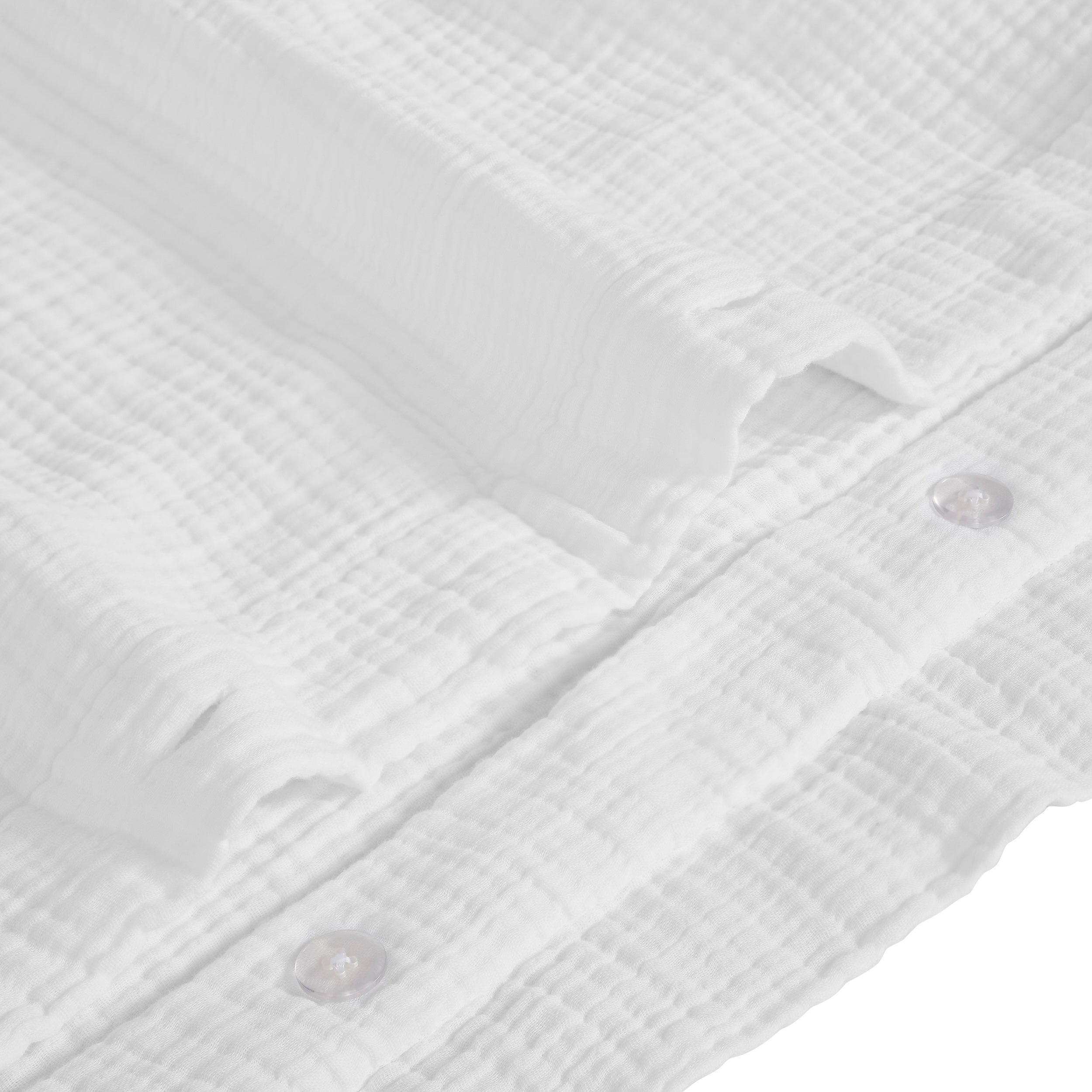 DT-048-10692_8|Extreme close-up of white crinkled textured cotton gauze fabric, showcasing the duvet cover's soft feel and subtle button details.