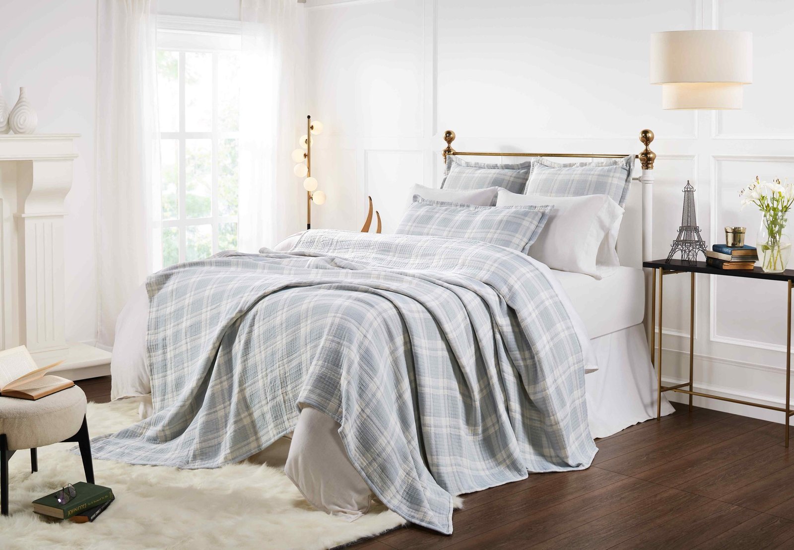 BT-117-11096_5|Light blue and white plaid patterned cotton quilt blanket draped over a bed, creating a cozy and stylish bedroom aesthetic.