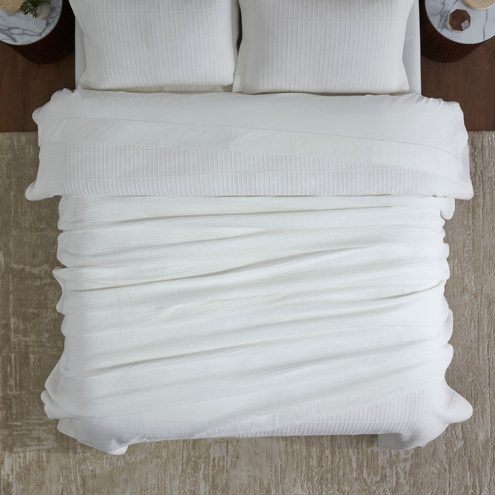 BL-861-11096_4|Overhead view of a white crinkle cotton blanket neatly arranged on a bed, showcasing luxurious, crisp, clean bedding.