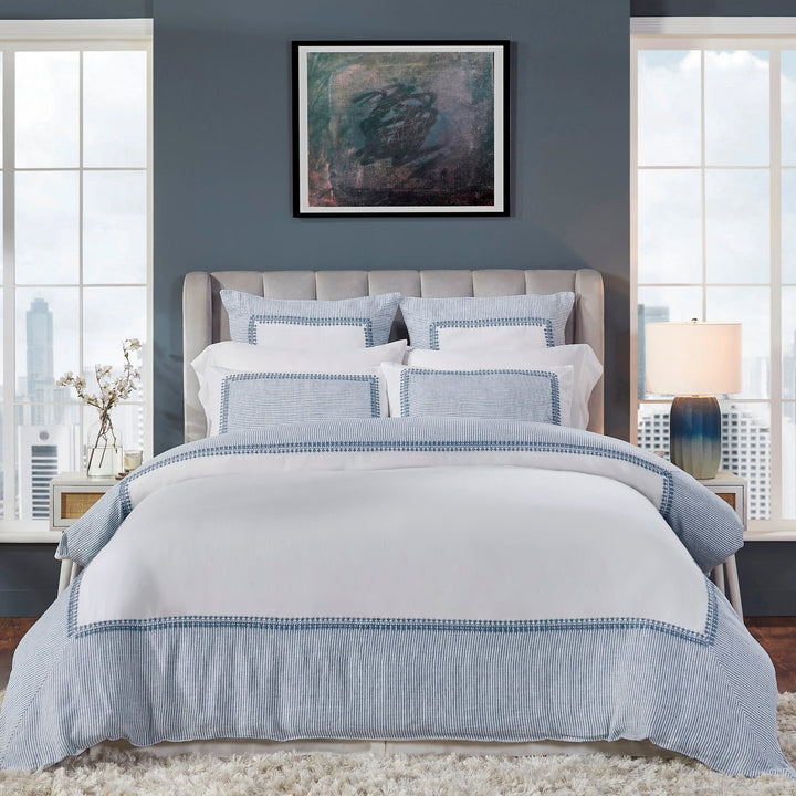 DT-030-10692_1|Elegant white duvet cover featuring a sophisticated blue striped border with intricate embroidery, creating a chic, inviting bedroom.