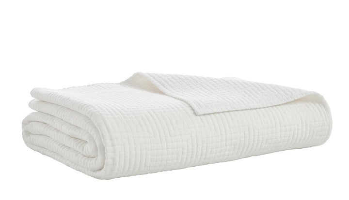 CL-199-11096_7|White quilted coverlet, elegantly folded, showcasing its detailed geometric maze pattern. Perfect for cozy bedding.