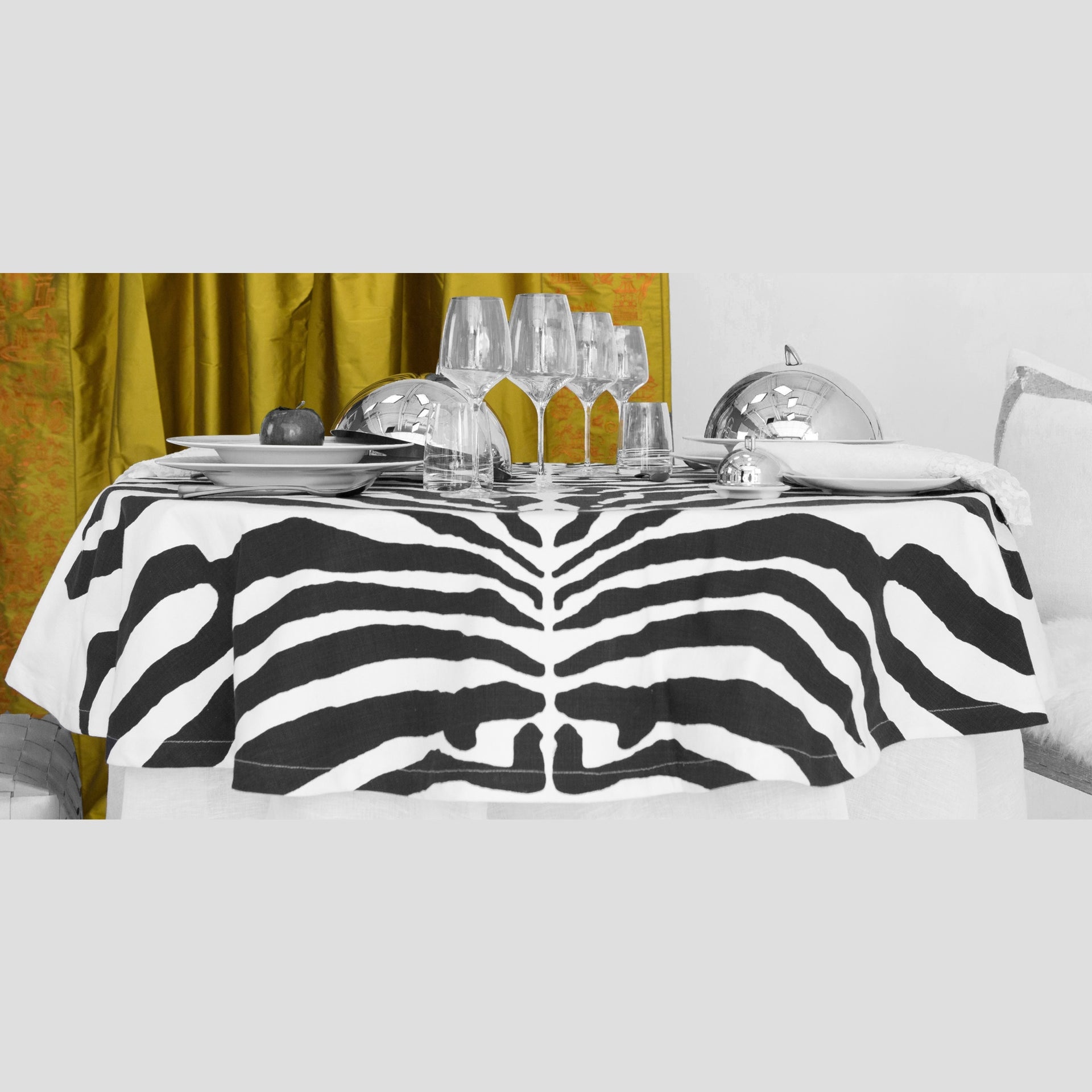 TC-4501B-60120_1|Elegant zebra print table cloth covering a dining table, set with sophisticated place settings. Stylish dinner decor.
