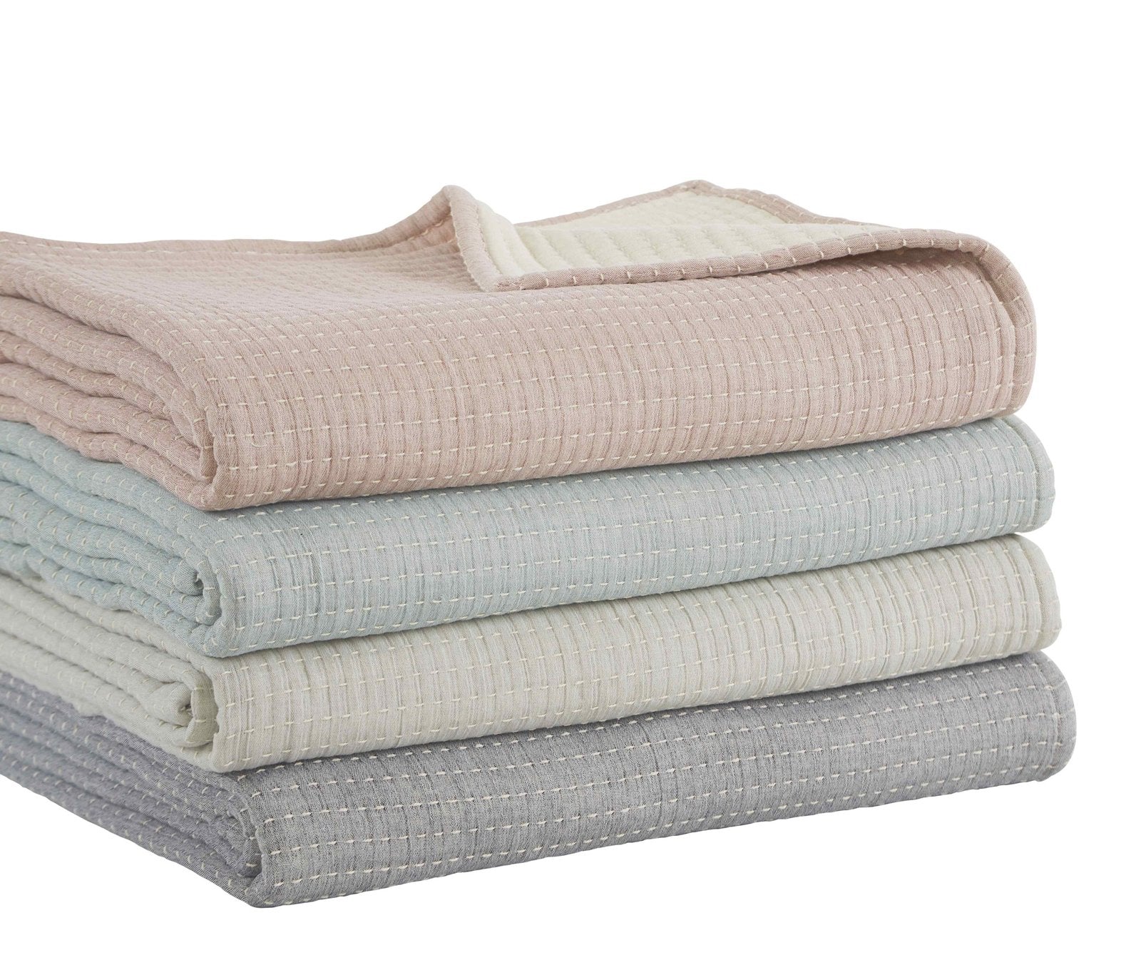 BT-106-9496_3|Stack of four folded textured reversible quilt blankets: soft pink, tranquil blue, creamy white, and neutral grey for varied bedding.