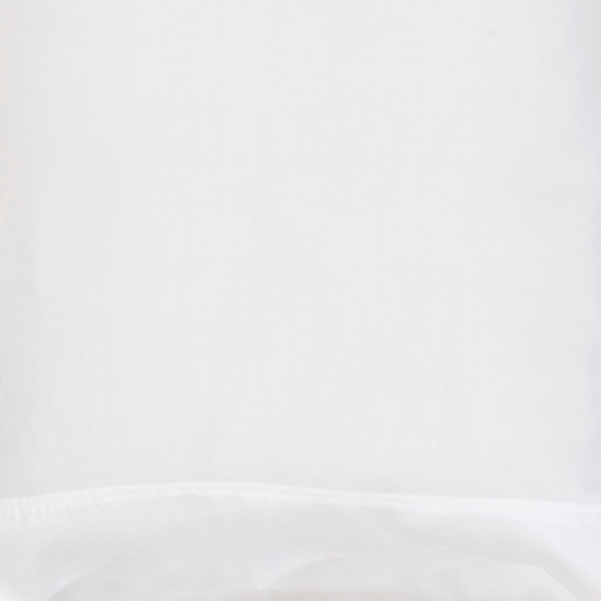 QFT-509-6080_6|Close-up of white 100% Lyocell flat sheet fabric, showing a smooth, subtle sateen weave texture and a neat hem with single stitching.