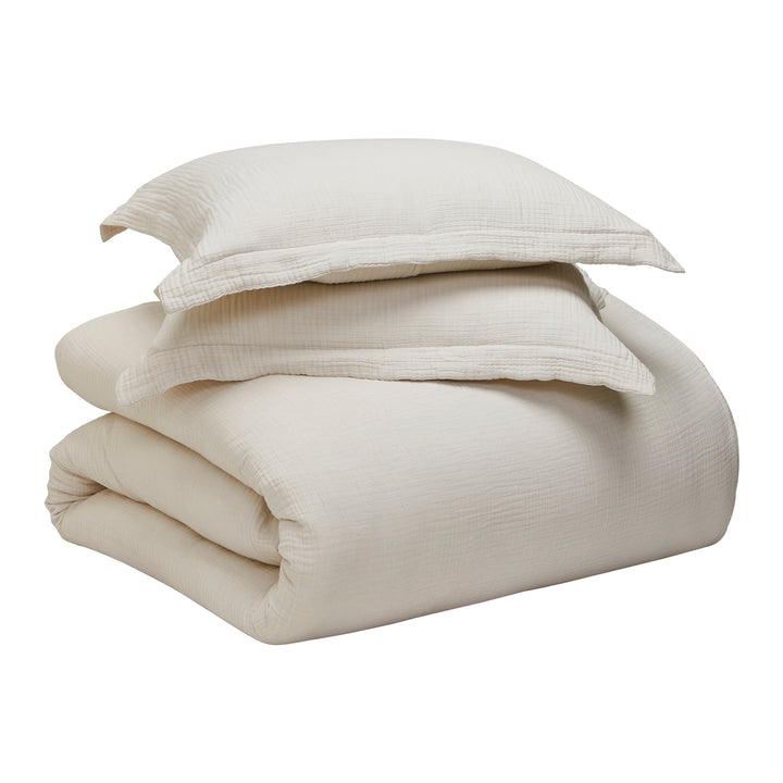 DT-049-9092_9|Complete cream textured duvet cover set with matching pillow shams, neatly folded for elegant bedroom styling.