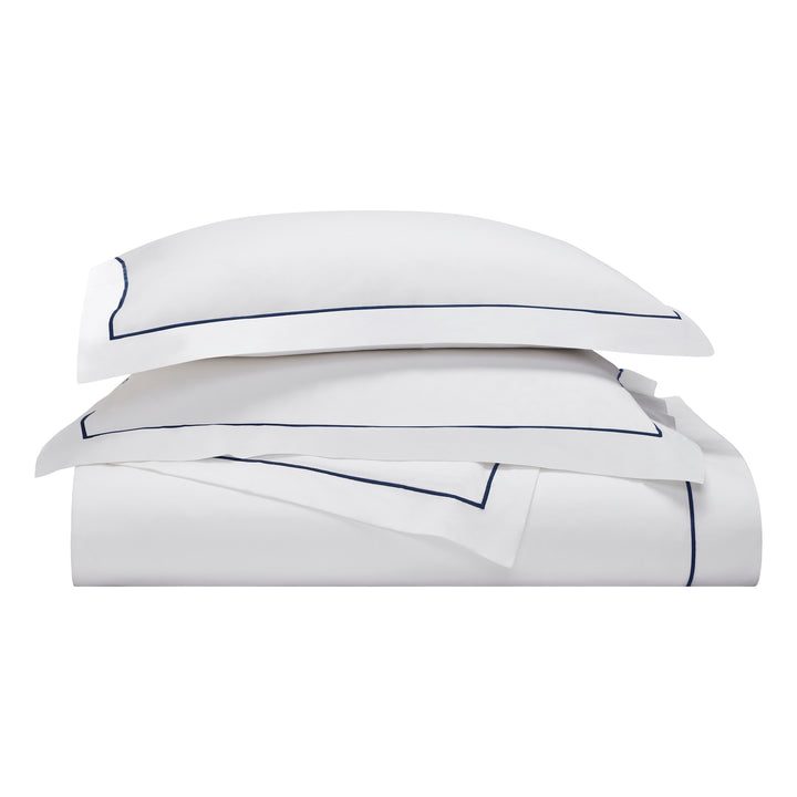 BS-070-1216_3|Stacked luxury white duvet cover set with sharp navy blue borders. Elegant and tailored cotton bedding for modern bedrooms.