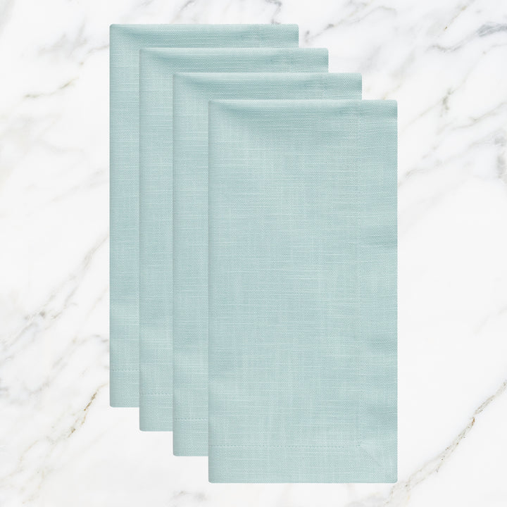 NP-4803-2020_1|Set of four folded aqua blue linen-blend napkins on marble. Stylish reusable cloth for weddings, parties, and daily meals.