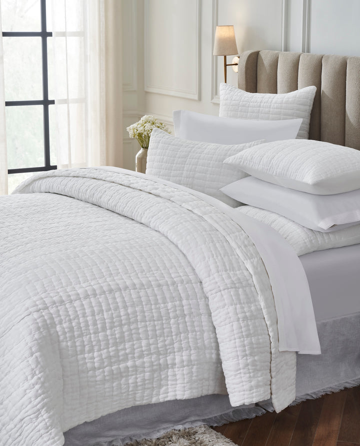 QT-372-11096_3|Close-up of soft white textured quilt and pillows, highlighting the elegant bedding for a serene and comfortable bedroom.