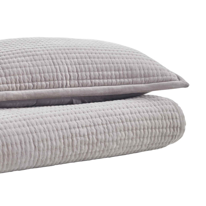 CL-188-9496_2|Stack of a light grey textured coverlet and matching pillow sham, highlighting their soft channel quilt texture.
