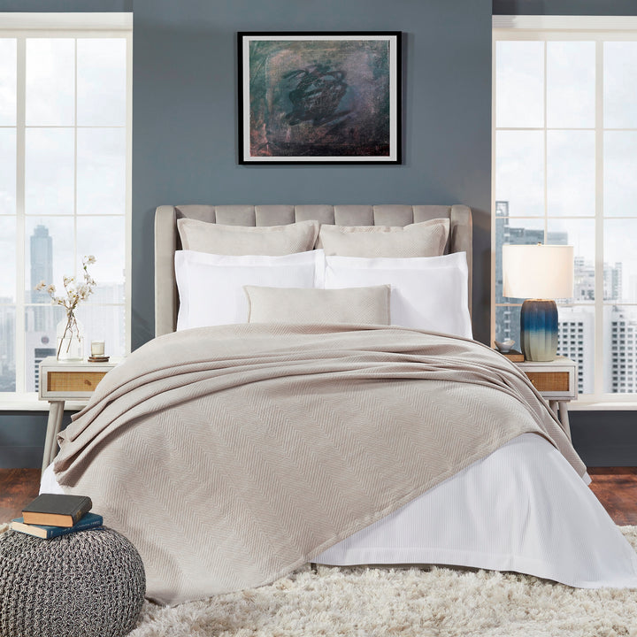 BT-122-9496_1|Elegant light beige chevron patterned blanket draped on a modern bed, creating a warm, inviting ambiance.