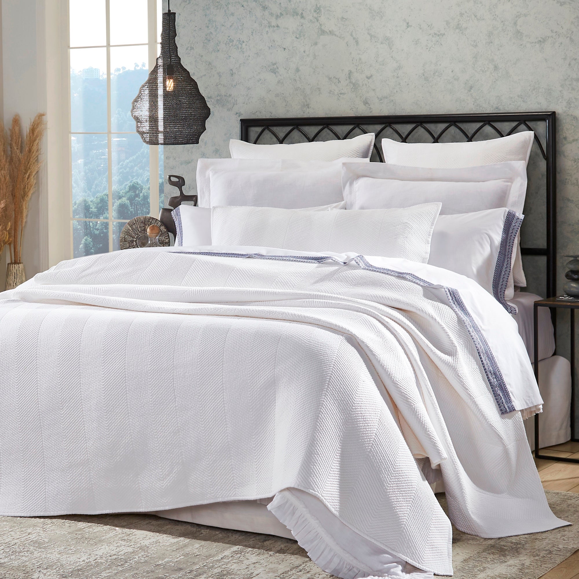 CL-170-9496_2|Luxurious white chevron patterned coverlet draped over a neatly made bed, adding a touch of elegance to bedroom decor.
