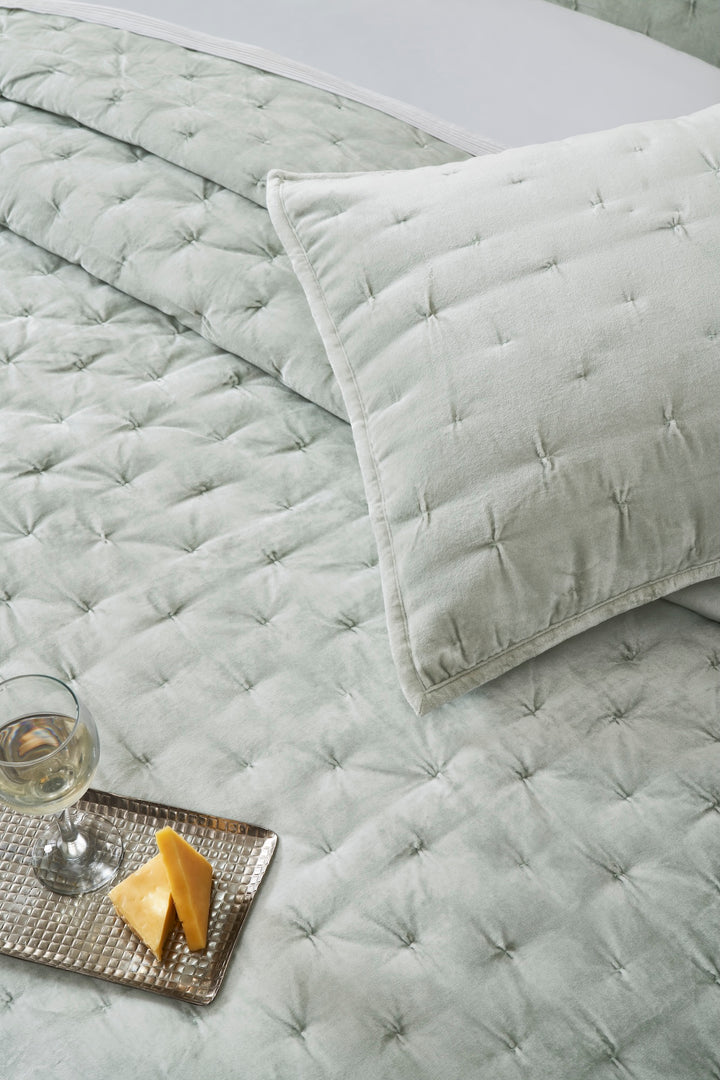 QT-371-11096_4|Overhead view of a soft sage green velvet quilt with uniform square tufting, cozy and inviting for relaxation.