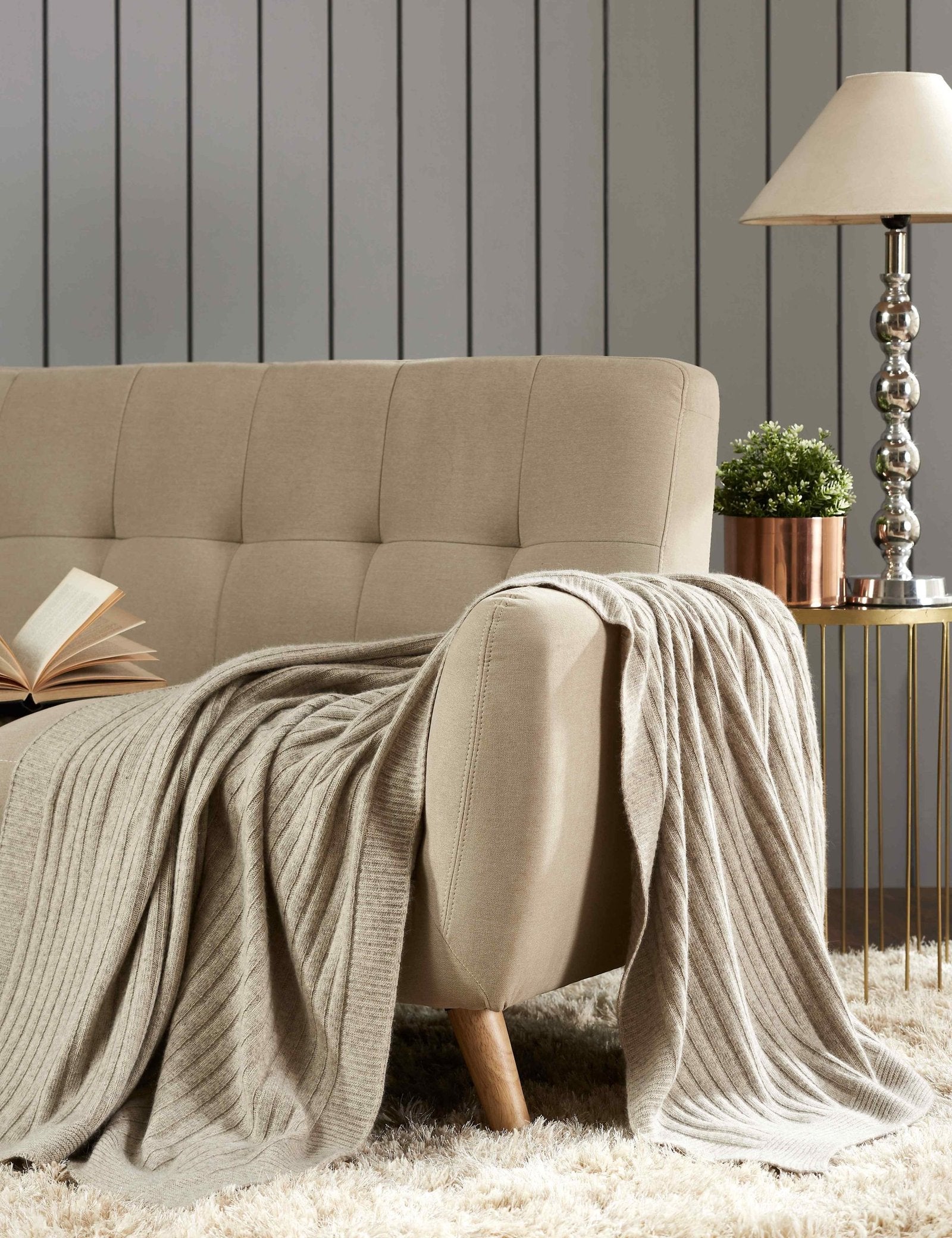 TW-901A-X_1|Cozy beige ribbed knit throw blanket elegantly draped over a sofa, adding warmth and texture to any living room.