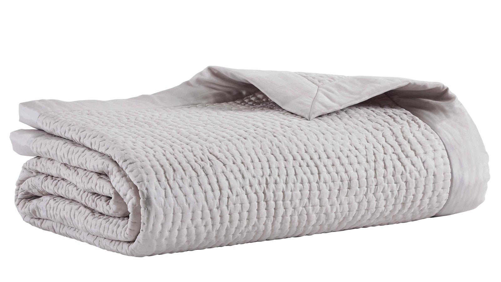 CL-166-9496_5|Folded light grey textured quilted coverlet, showcasing its soft fabric and inviting texture, ready for a cozy bed.