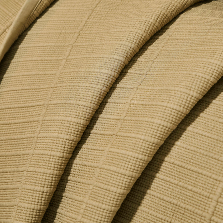 CL-269-9496_8|Detailed close-up of a tan coverlet's plush, ribbed woven texture, highlighting the soft fabric folds and luxurious material.