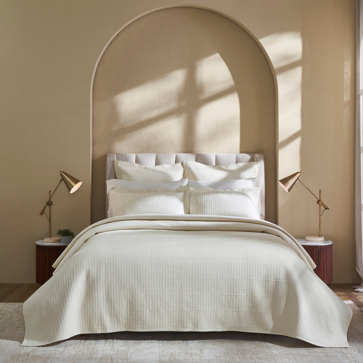 CL-271-9496_2|Luxurious cream textured coverlet with subtle grid pattern, draped elegantly on a bed, offering sophisticated comfort for modern bedrooms.