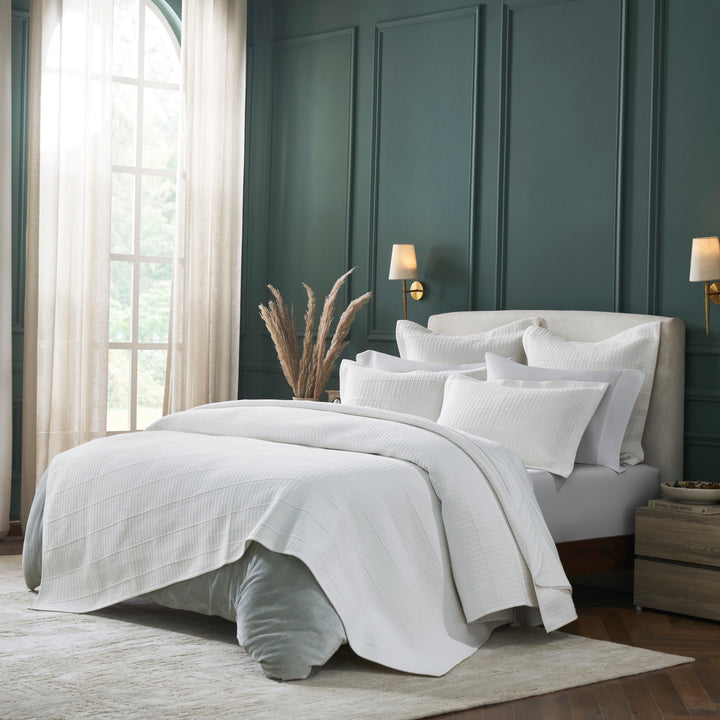 CL-268-11096_2|Luxurious white textured coverlet draping elegantly over a king-size bed, featuring a modern striped pattern for sophisticated bedding.