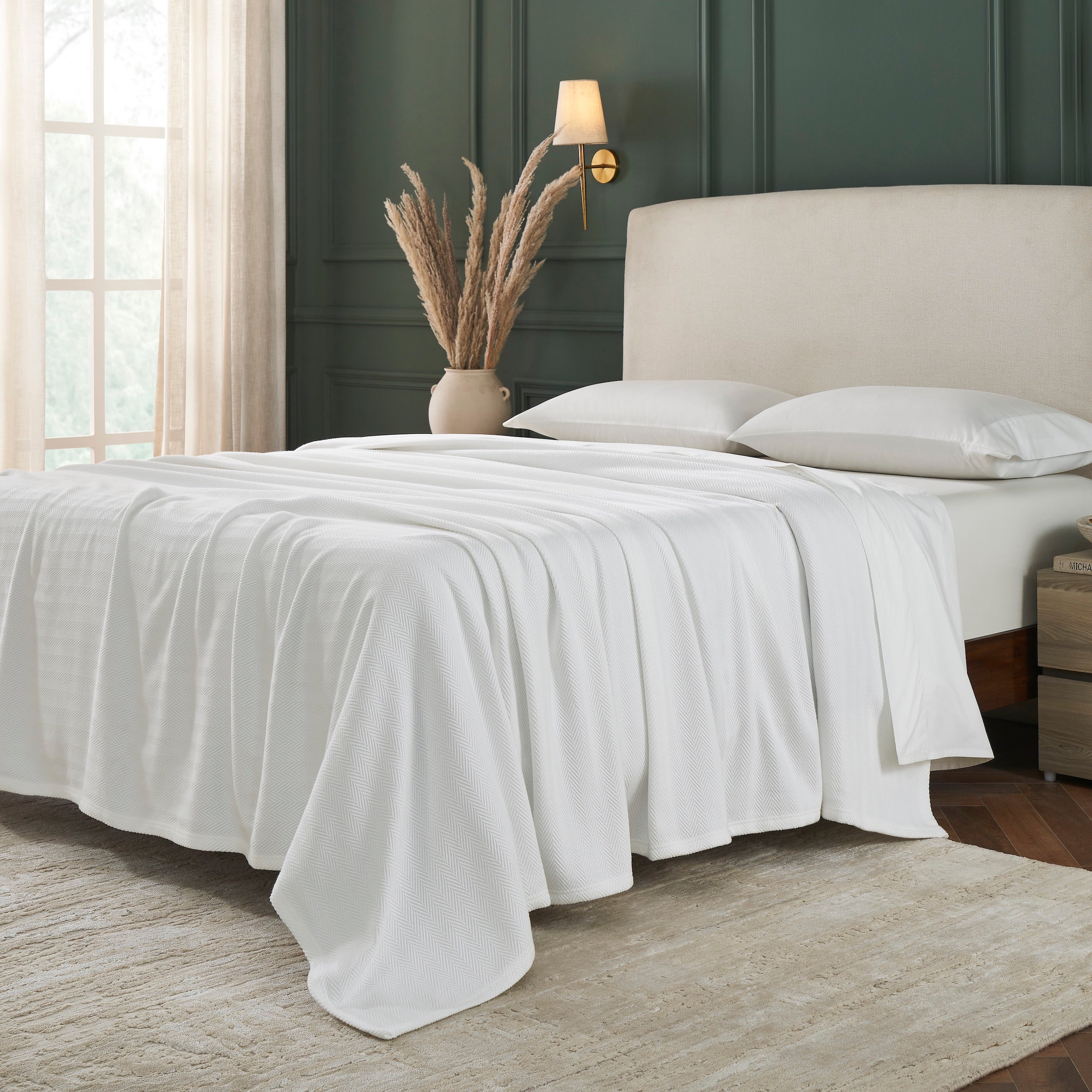 BL-865-11096_2|White textured blanket fully covering a comfortable bed, showcasing its subtle pattern and inviting, cozy warmth for any bedroom.