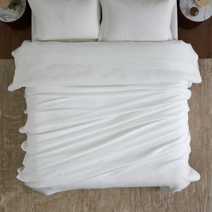 BL-858-11096_4|Soft white textured blanket providing a cozy and inviting feel, perfectly covering the bed in a serene bedroom setting.