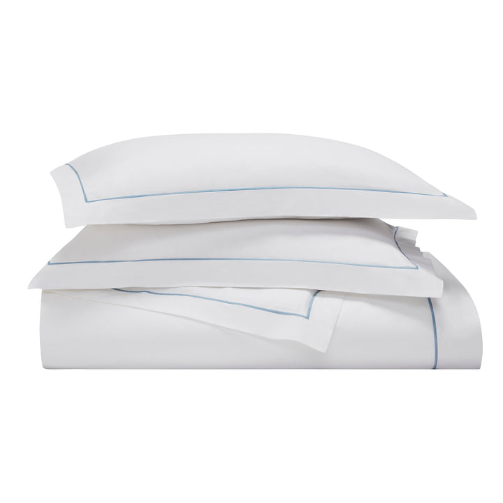 DT-055-9092_4|Crisp white folded duvet cover with elegant light blue piping detail. Premium quality cotton bedding for a fresh, clean bedroom look.