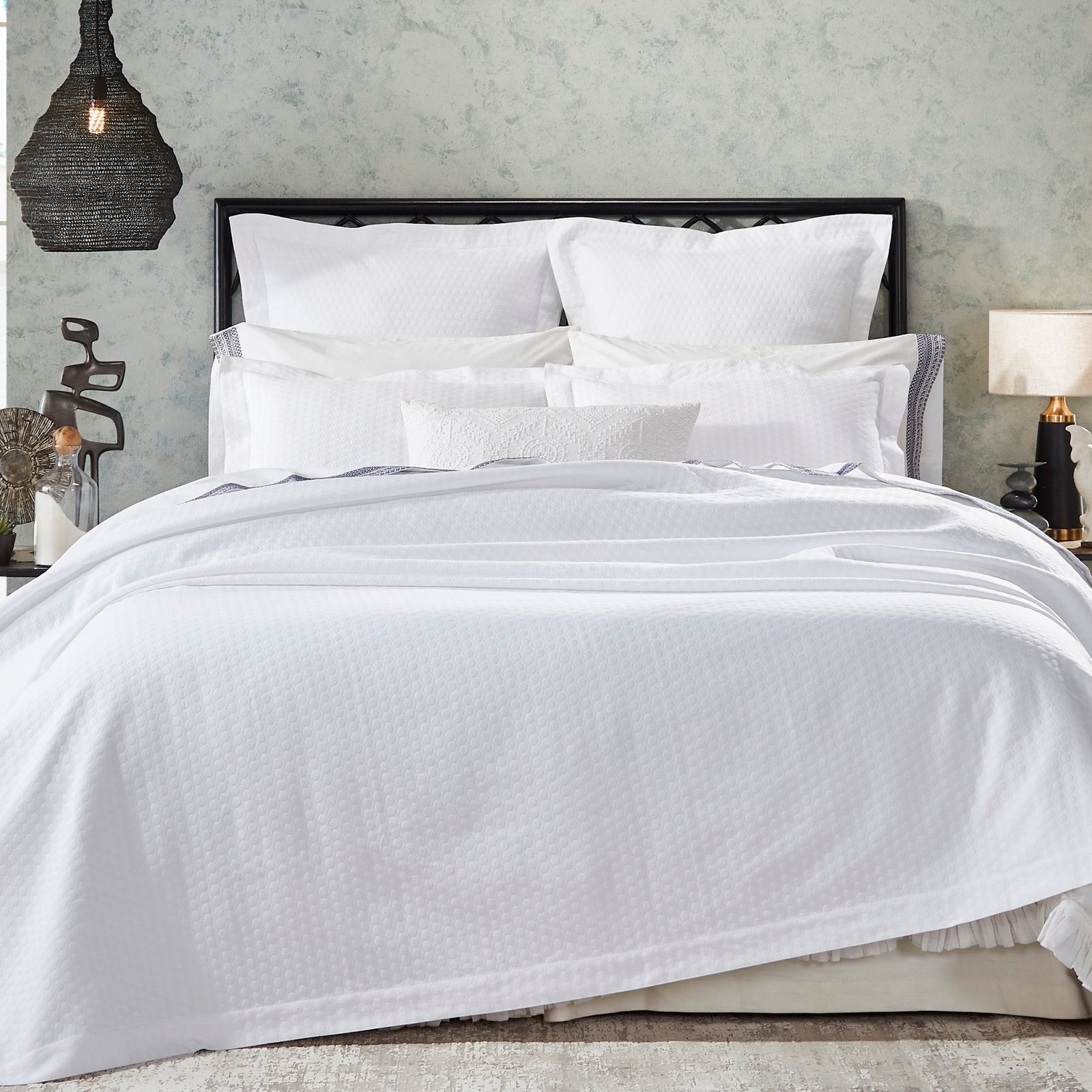 CL-174-X_1|Crisp white patterned duvet coverlet and a full set of pristine white bedding creating an elegant and inviting bedroom scene.