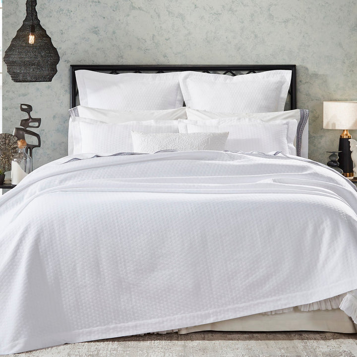 CL-174-X_1|Crisp white patterned duvet coverlet and a full set of pristine white bedding creating an elegant and inviting bedroom scene.