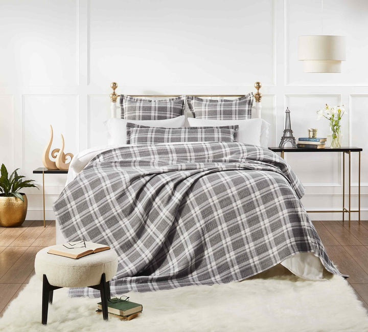 BT-116-9496_1|Stylish grey and white plaid blanket elegantly draped on a bed, creating a cozy and inviting atmosphere.