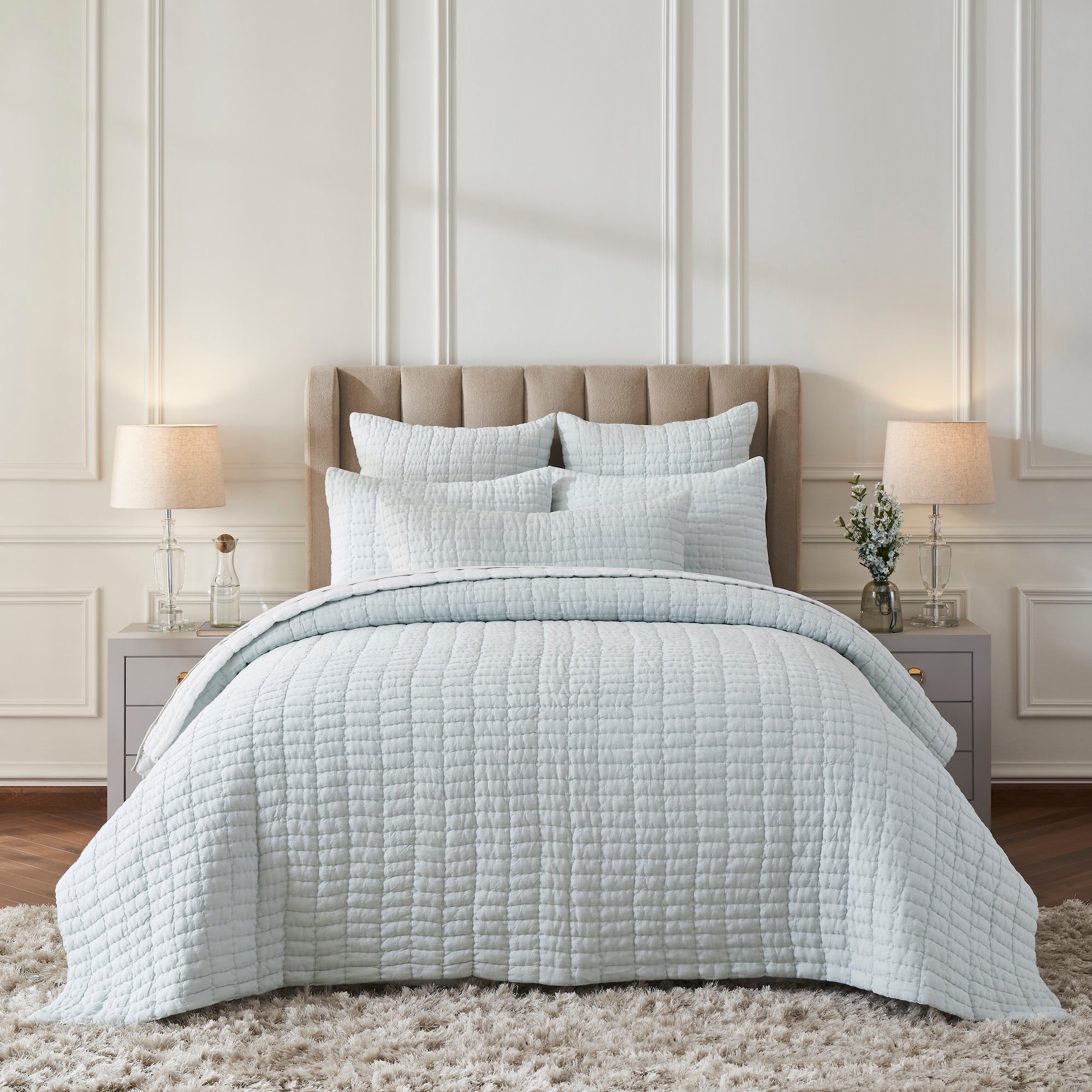 QT-373-11096_1|Elegant light blue textured quilt set adorns a serene bedroom, offering luxurious comfort and a clean, modern aesthetic.