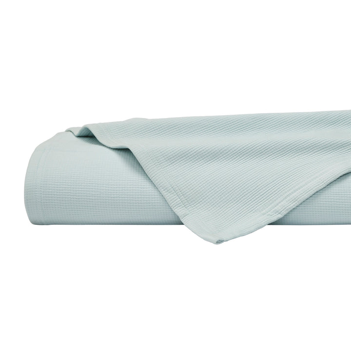 BL-859-11096_8|Close-up of a folded light blue waffle weave blanket, showcasing its texture. Ideal for bedroom decor or a cozy throw.