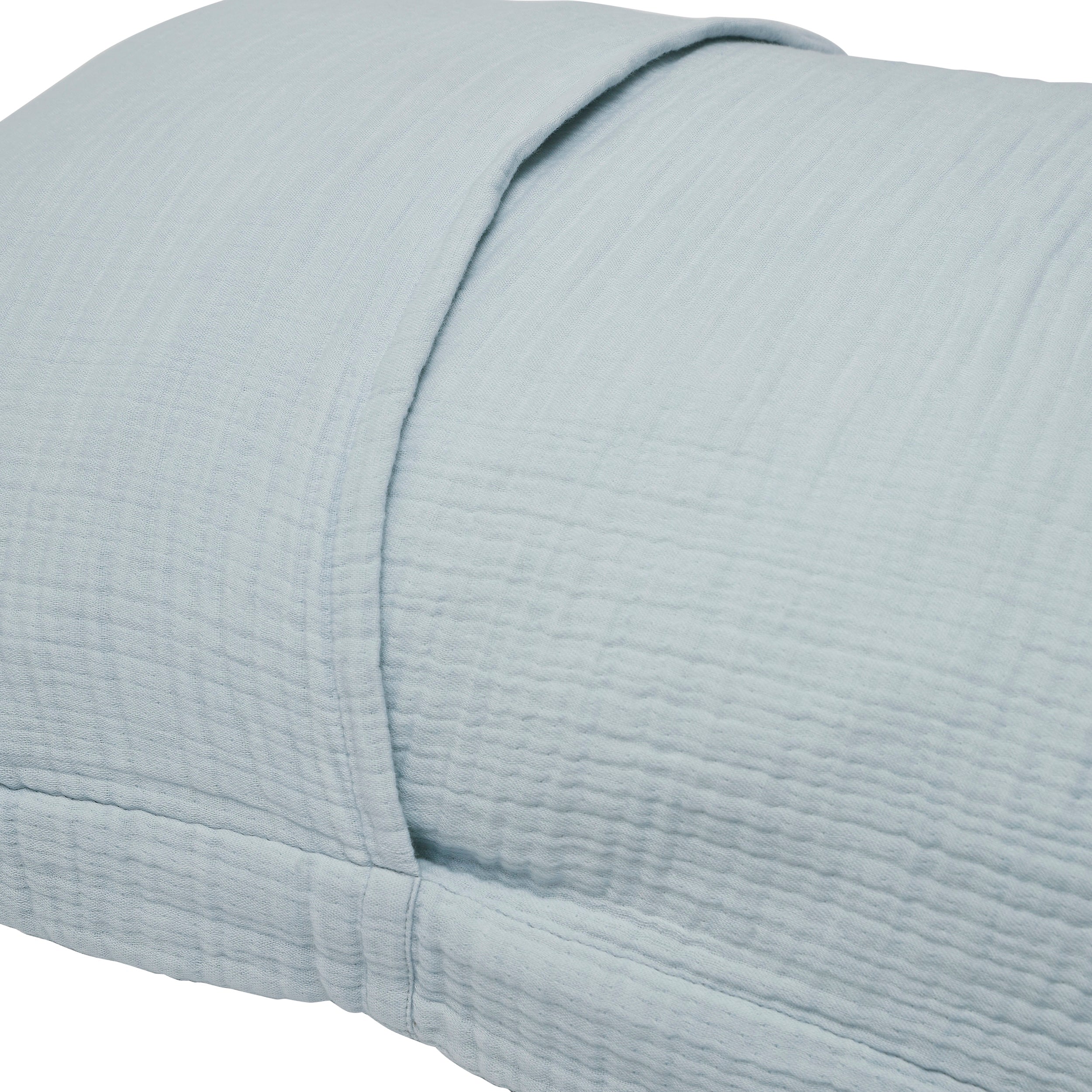 SS-050-2026_2|Close-up of a serene light blue organic cotton duvet cover with a soft, crinkled texture, highlighting its subtle folds.