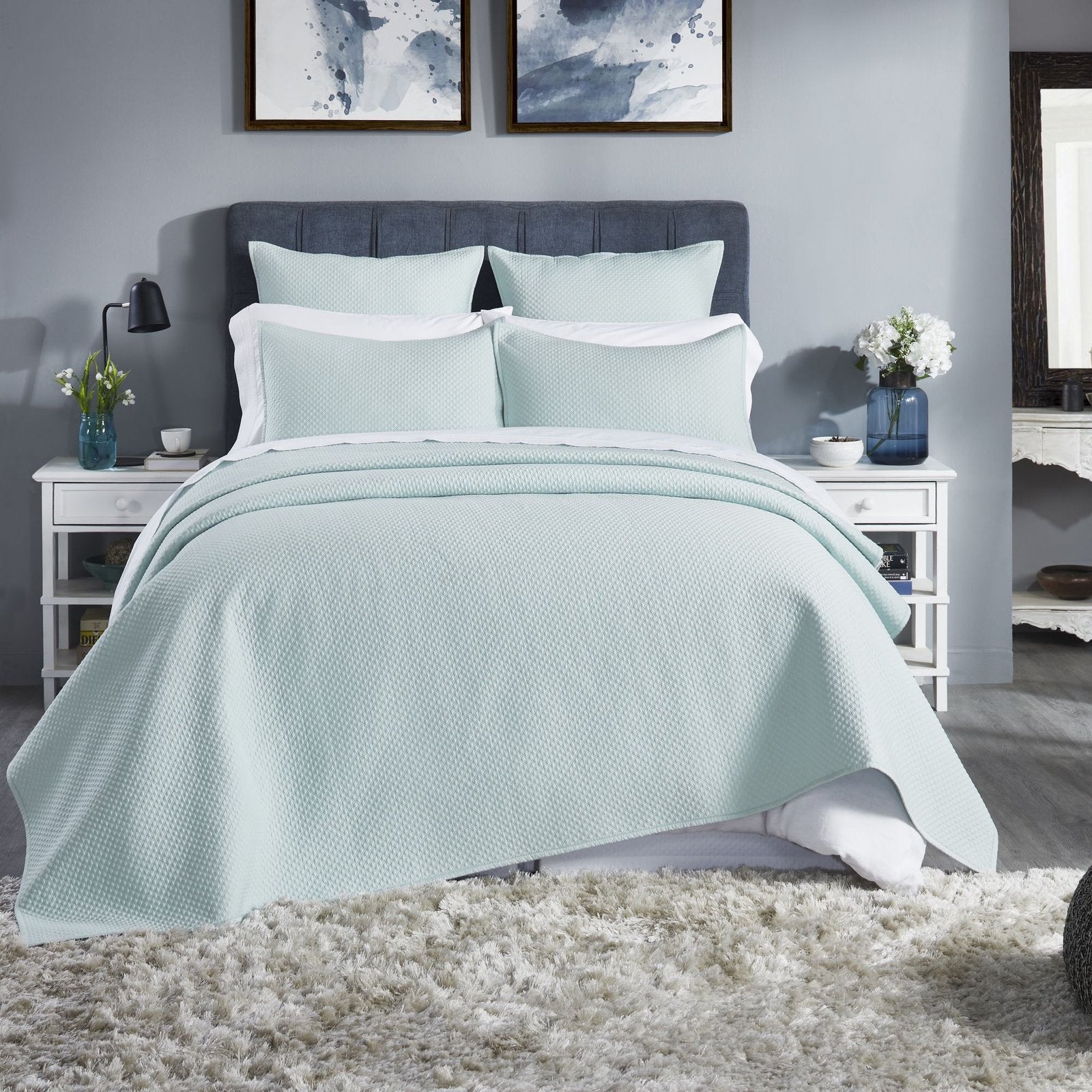 CL-252-9496_1|Refreshing mint green quilted coverlet adorning a stylish bed, offering cozy comfort and elegant modern bedroom appeal.