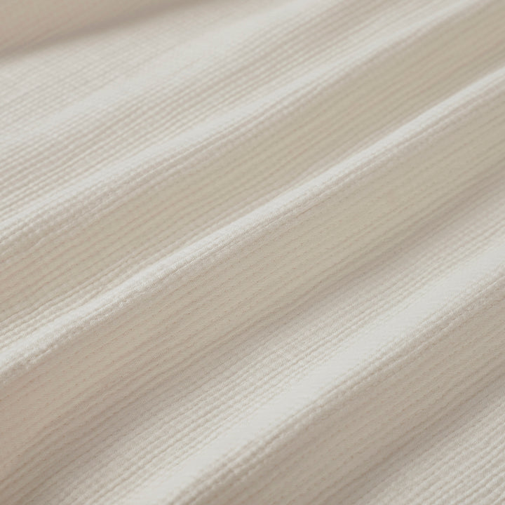 BL-860-11096_9|Cream waffle weave blanket texture close-up, showcasing soft folds and cozy fabric detail for comfortable bedding.