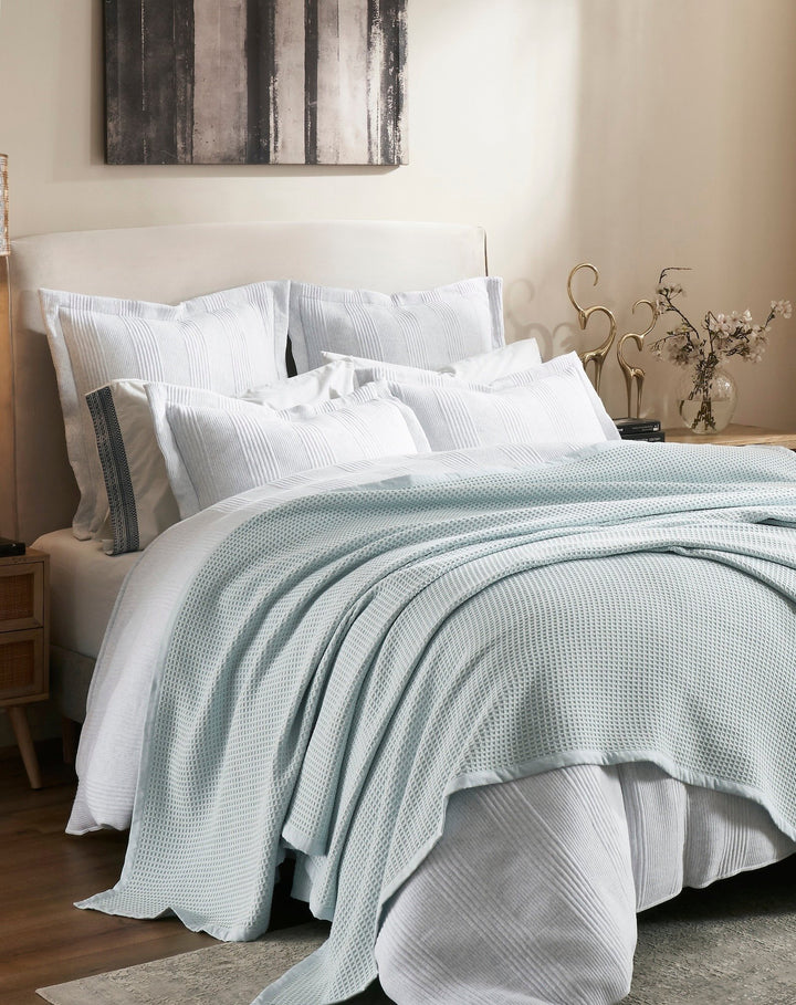 BL-857-9496_3|Light blue waffle knit blanket on a neatly made bed, providing cozy, elegant bedroom decor comfort. (112)