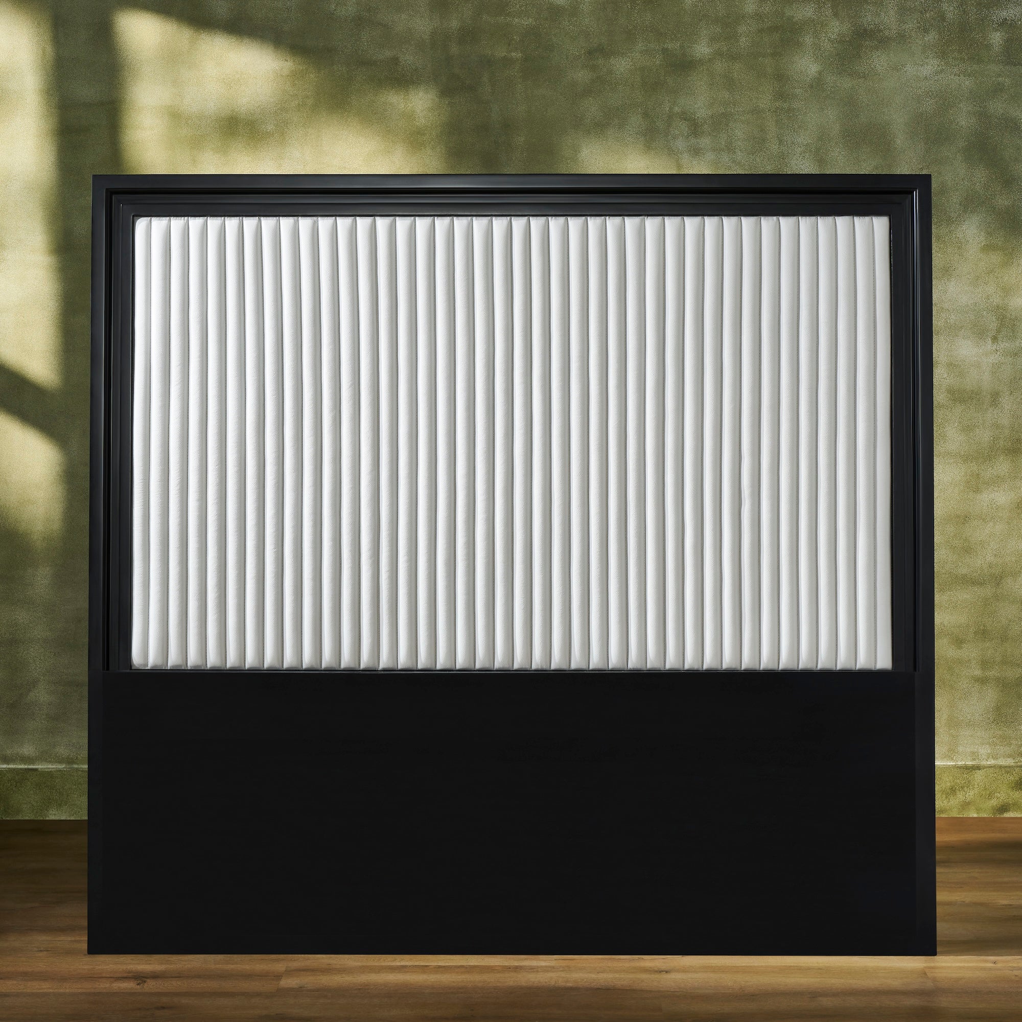 FN-5211-7680_1|Rectangular black framed headboard with a white vertically channel-quilted leather upholstered panel. Features a solid black base.