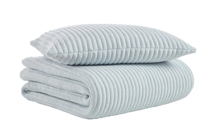 QT-369-9496_6|Folded light blue quilt and matching pillow with ribbed texture. Soft, comfortable bedding set for a modern bedroom.