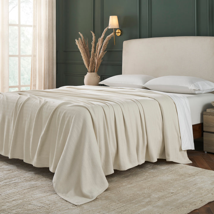 BL-866-9496_2|Cozy light beige herringbone woven blanket fully covering a luxurious bed, offering inviting warmth and sophisticated texture.