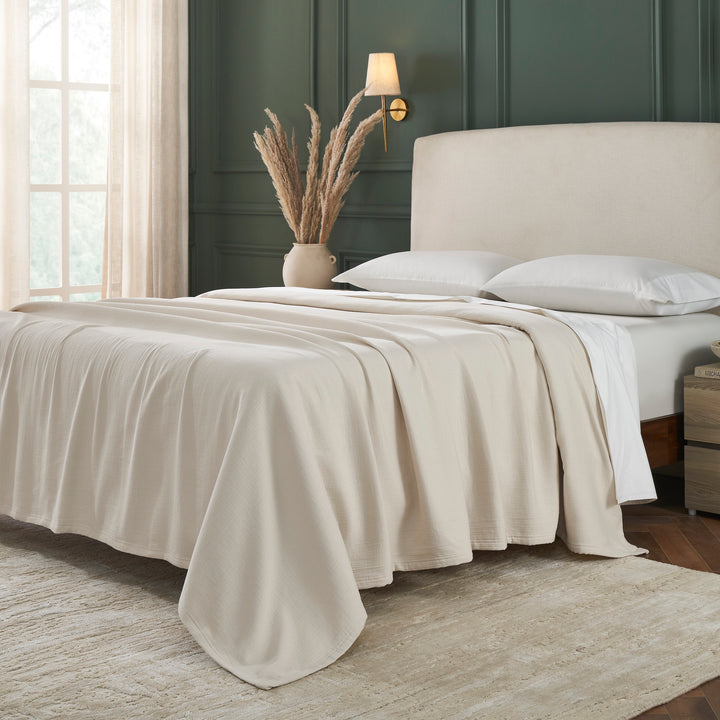 BL-860-11096_2|Comforting light beige textured blanket on a bed, offering a cozy and stylish layer for a relaxing modern bedroom setting.