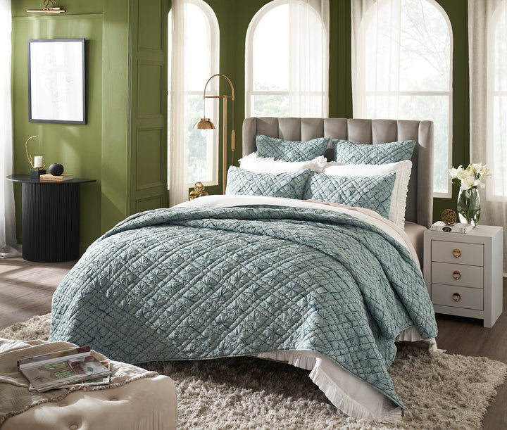 QT-365-11096_2|Elegant teal geometric quilted quilt on a bed with ruffled white sheets, enhancing a vibrant, stylish bedroom.
