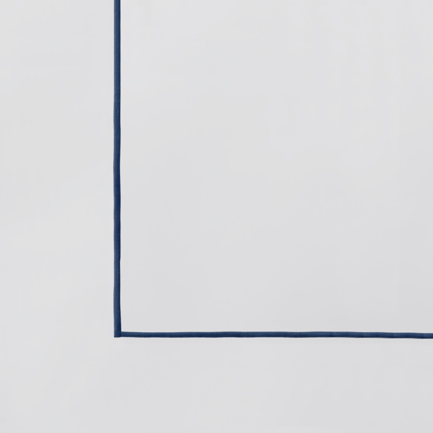 KS-070-2036_5|Close-up of a crisp white duvet cover with a tailored navy blue piping edge. Classic and elegant hotel collection bedding.