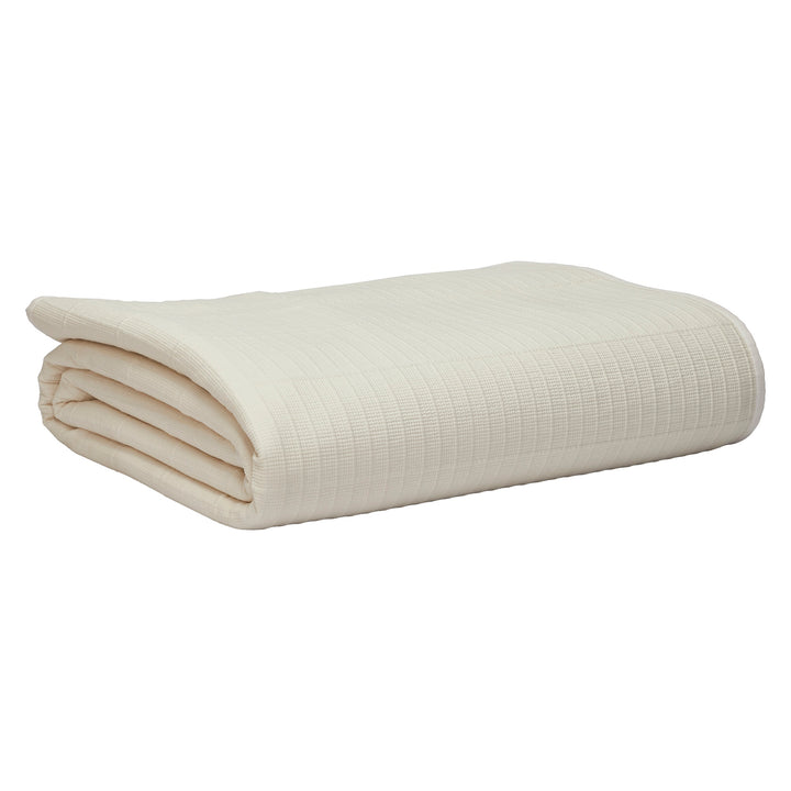 CL-271-11096_11|Folded cream textured coverlet with a subtle ribbed pattern, ideal for a lightweight bed throw or extra warmth.