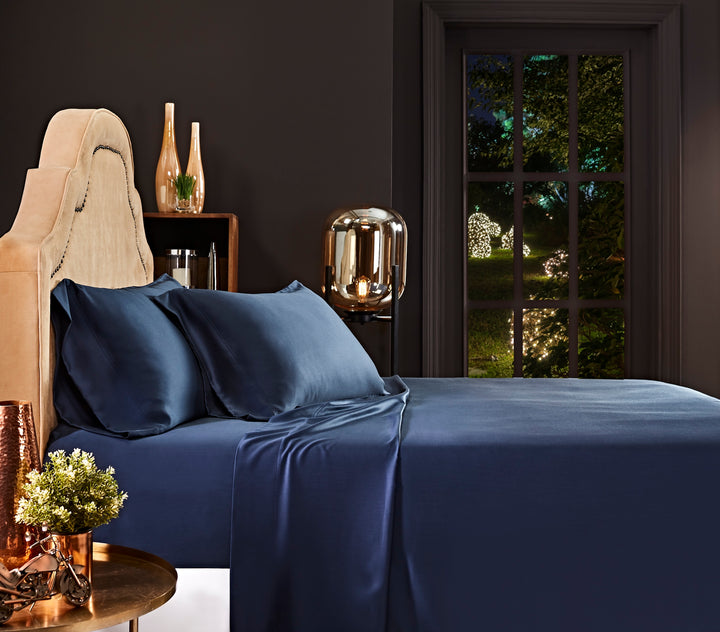 CSS-511-7284_1|Navy 100% Lyocell sheet set on a bed. Includes two pillowcases and a flat sheet with a smooth sateen weave.