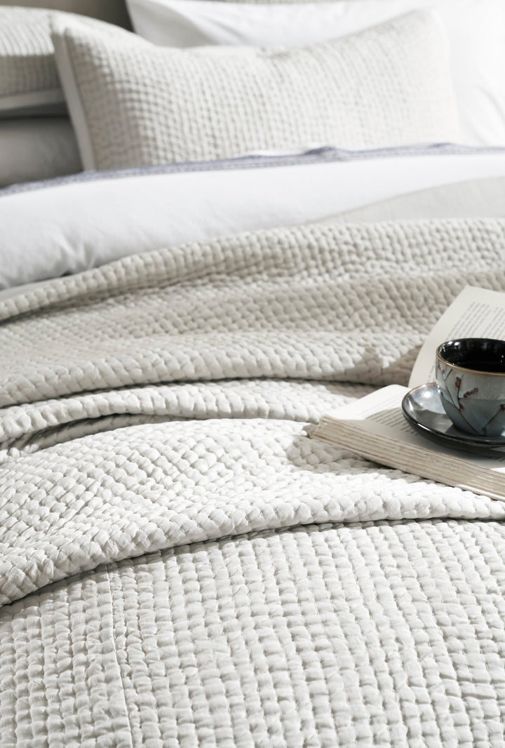 CL-197-9496_4|Close-up of a light grey coverlet showcasing its intricate waffle-knit texture, perfect for modern and cozy bedroom styling.